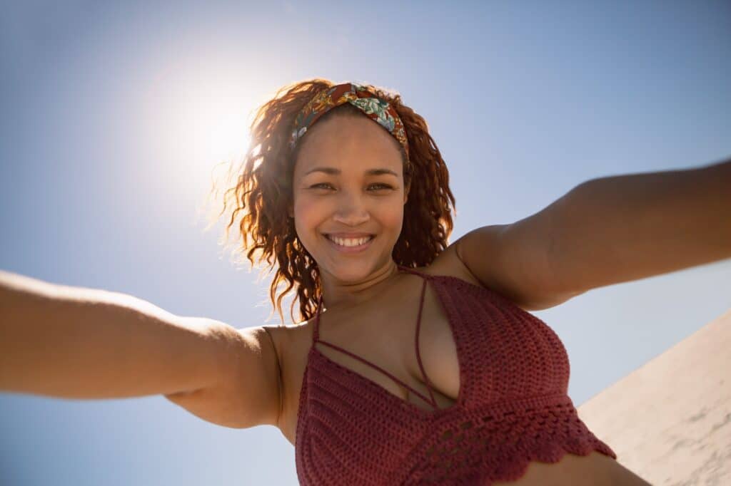 Portrait of beautiful mixed race woman standing on the beach